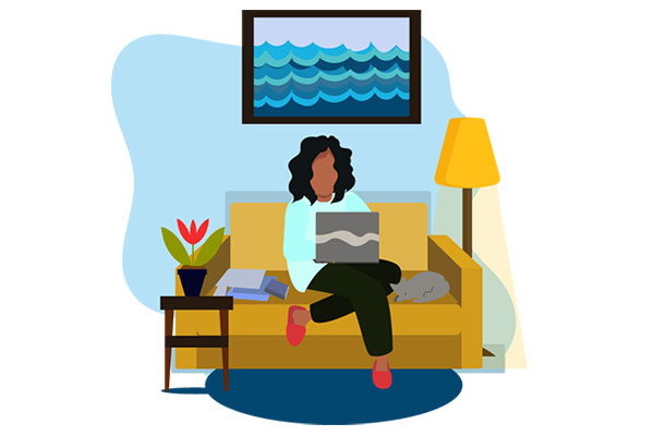 Lady using a laptop at home on her sofa