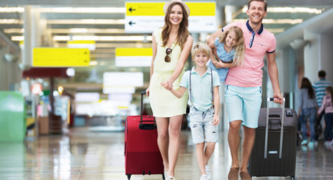 family walking through an airport terminal